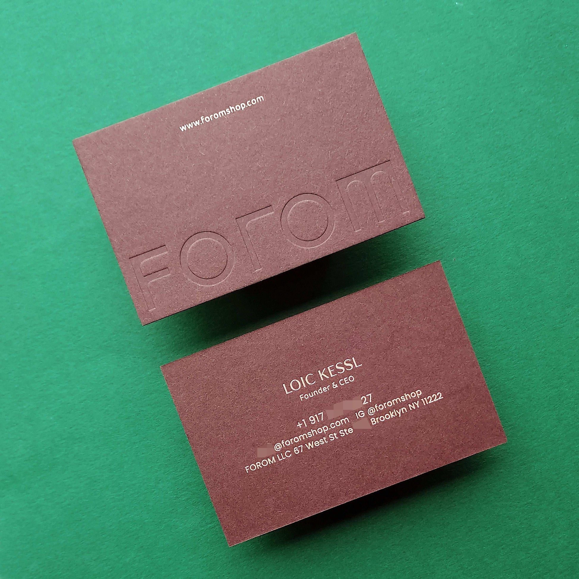 Custom thick brown business card with blind deboss and rush shipping.