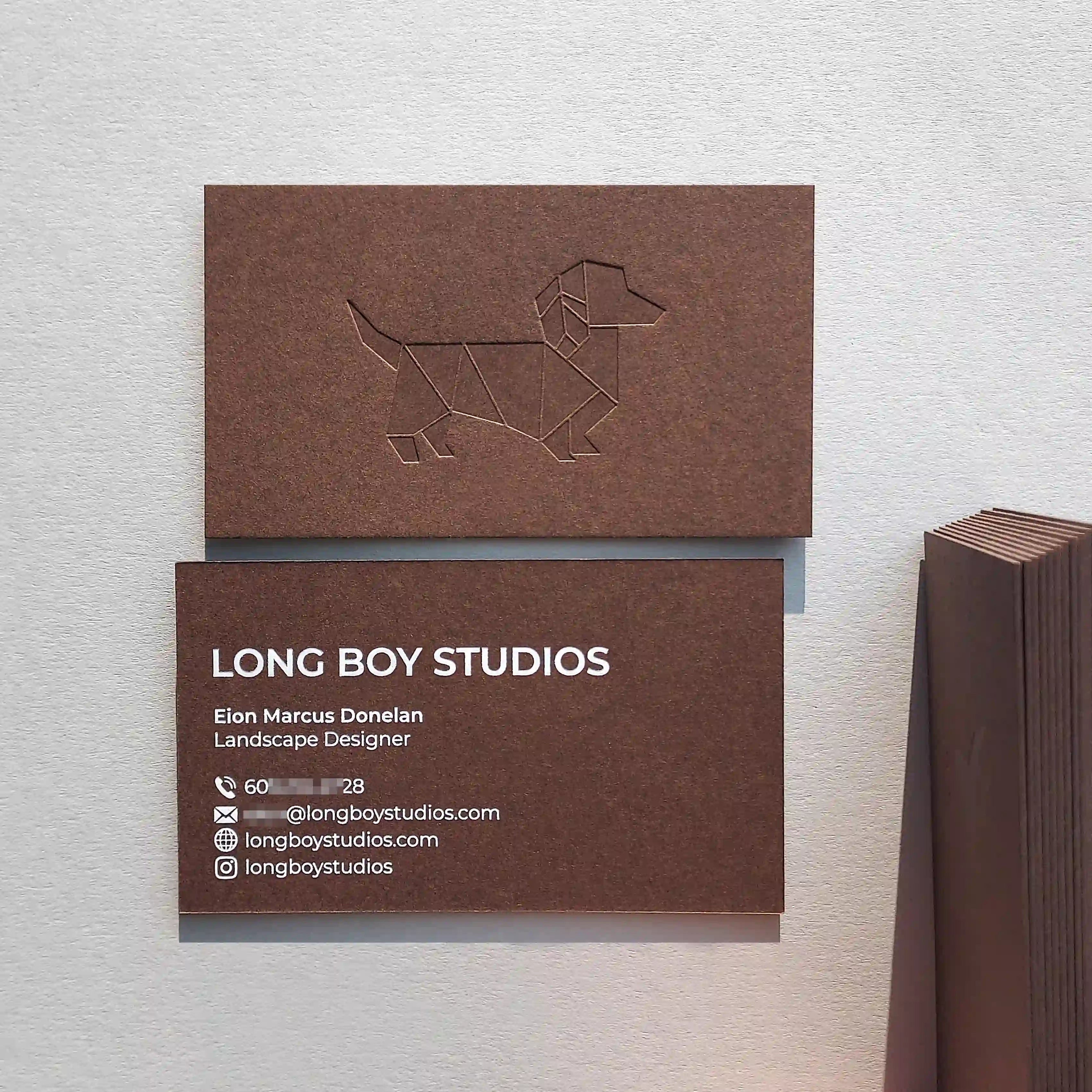 Brown business cards 30pt(540gsm) with deboss and white foil made by OddPlanPrint.