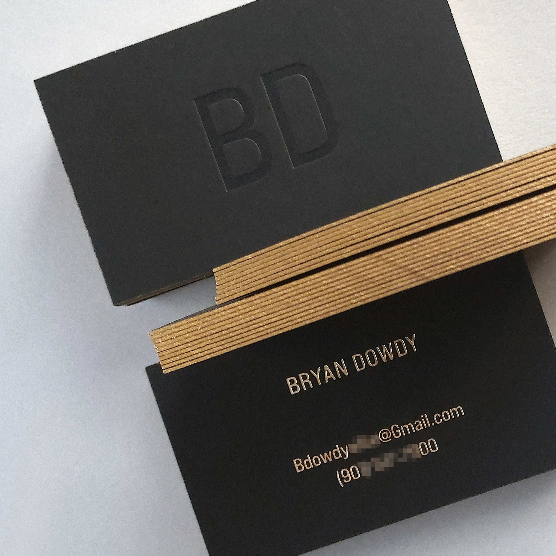 Premium custom black business card with bold blind deboss