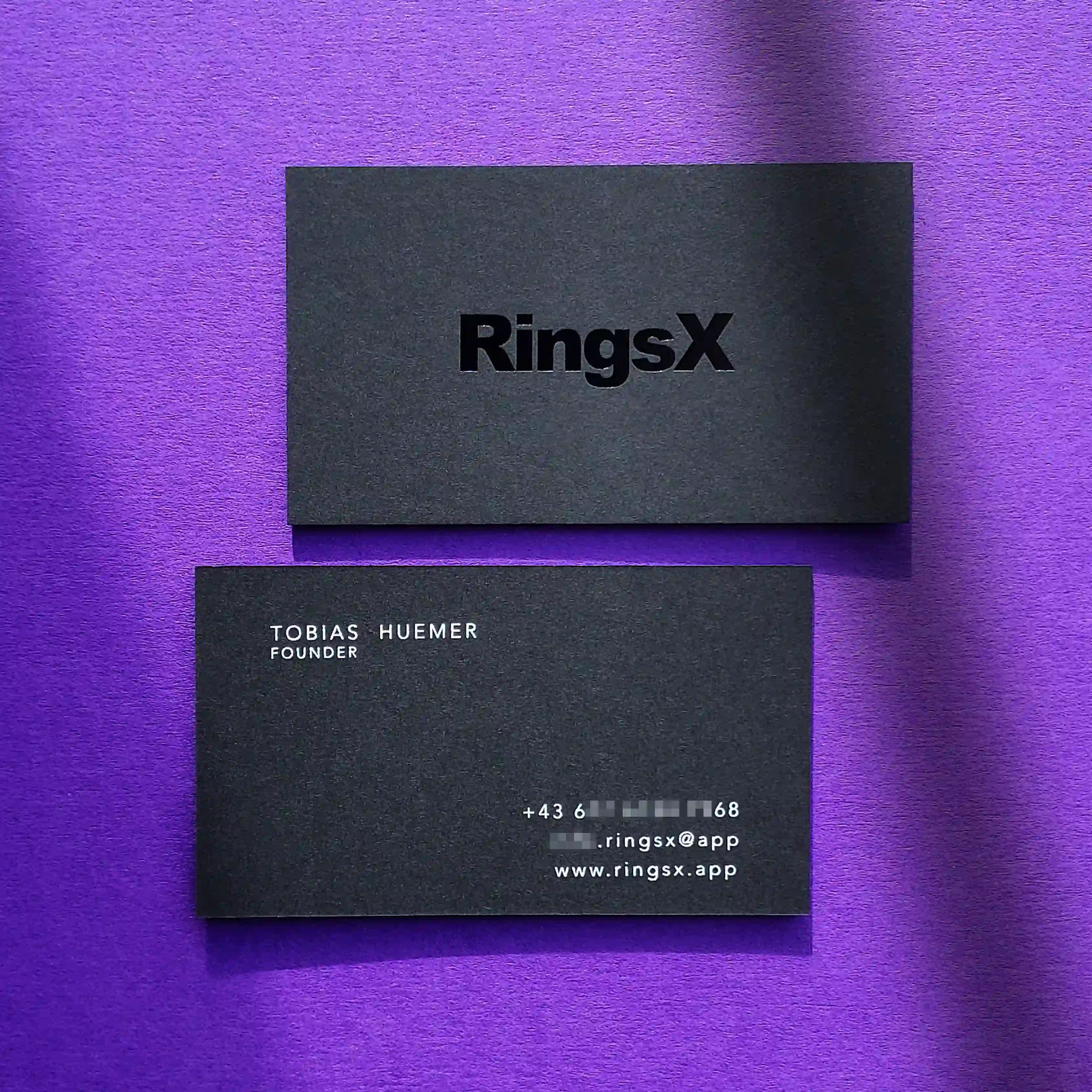 Bold black business cards 38pt thick with glossy black foil and white foil details produced by OddPlanPrint.