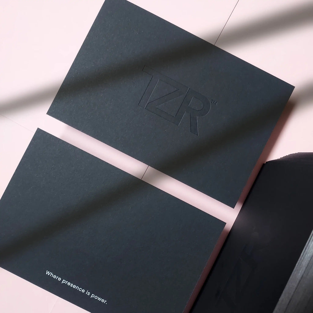 Premium black postcard with debossed logo, white foil headline and silver painted edges - OddPlanPrint