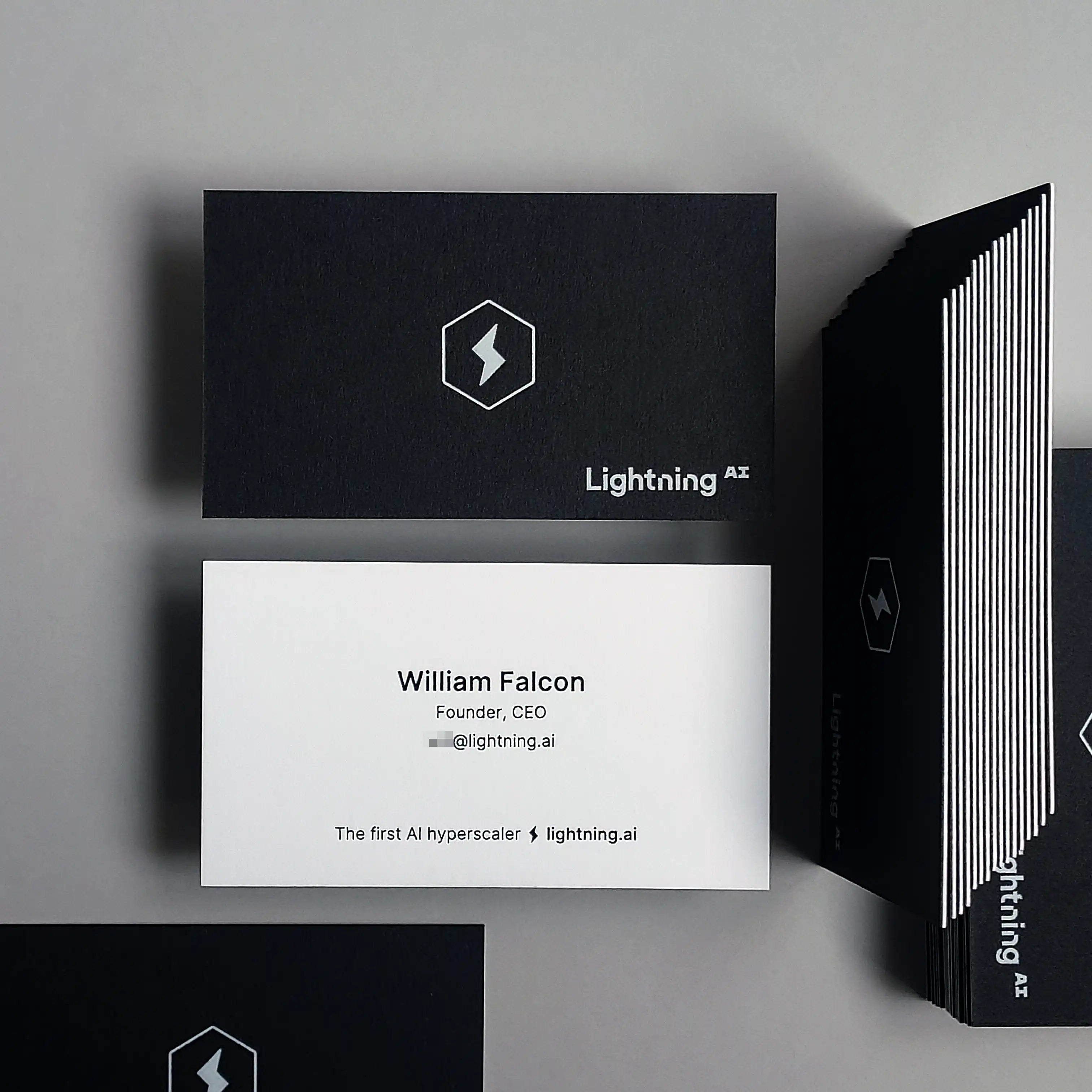 OddPlanPrint's 750gsm duplex business card, showcasing the elegant layering of black and white stock with contrasting white and black foil.