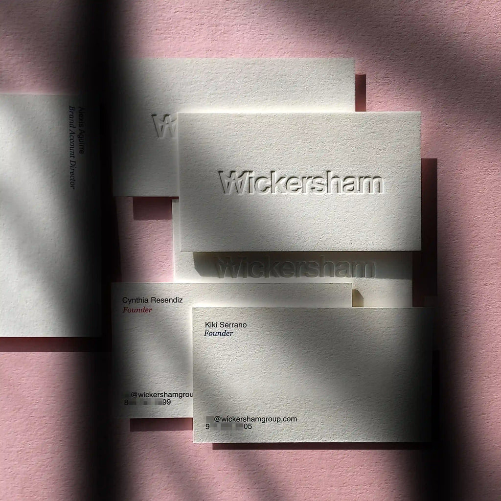 Blind letterpress business cards with cotton 45pt and dual Pantone details by OddPlanPrint.