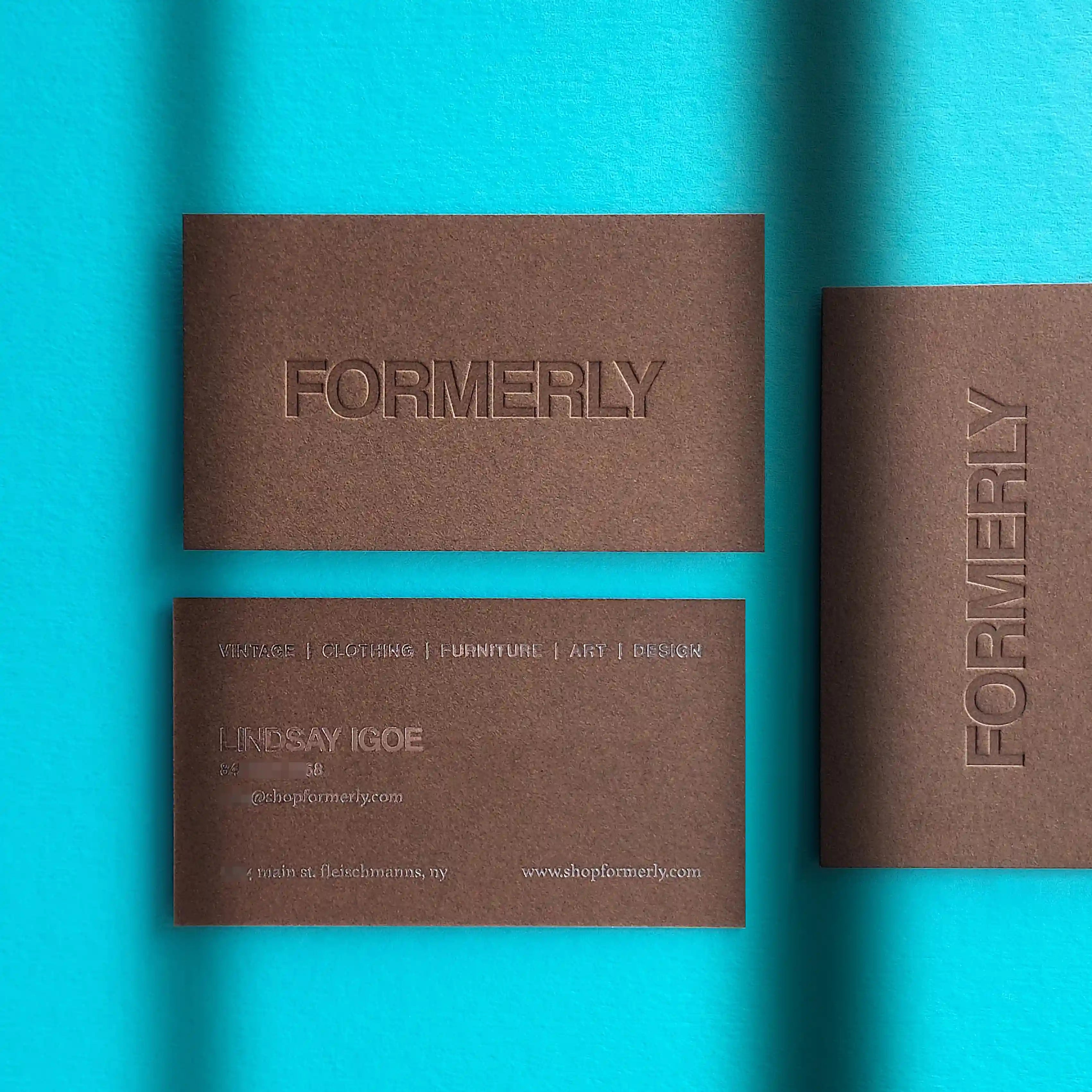 Bagdad brown business cards 30pt(540gsm) with deep deboss and chrome foil finishing made by OddPlanPrint.