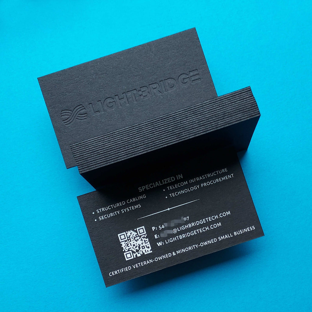 Luxury black card stock featuring white foil and deep deboss