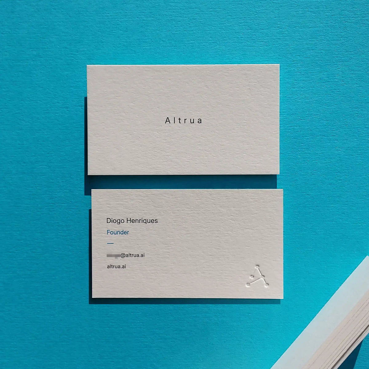 Deep debossed logo and vibrant blue and black Pantone printing on thick 38pt Colorplan Natural business cards by OddPlanPrint.