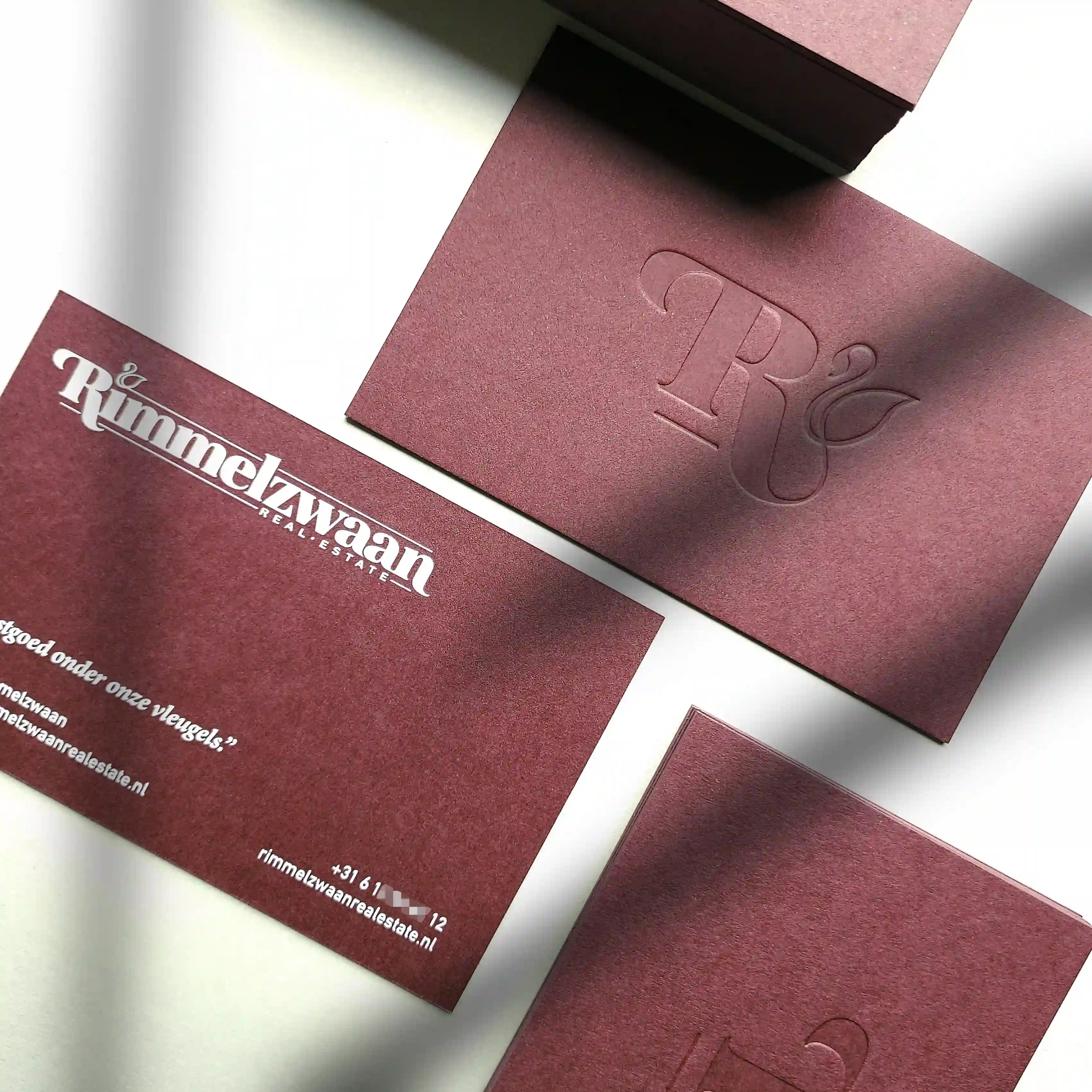 Colorplan Claret business cards 38pt 700gsm with blind deboss and white printing made by OddPlanPrint.