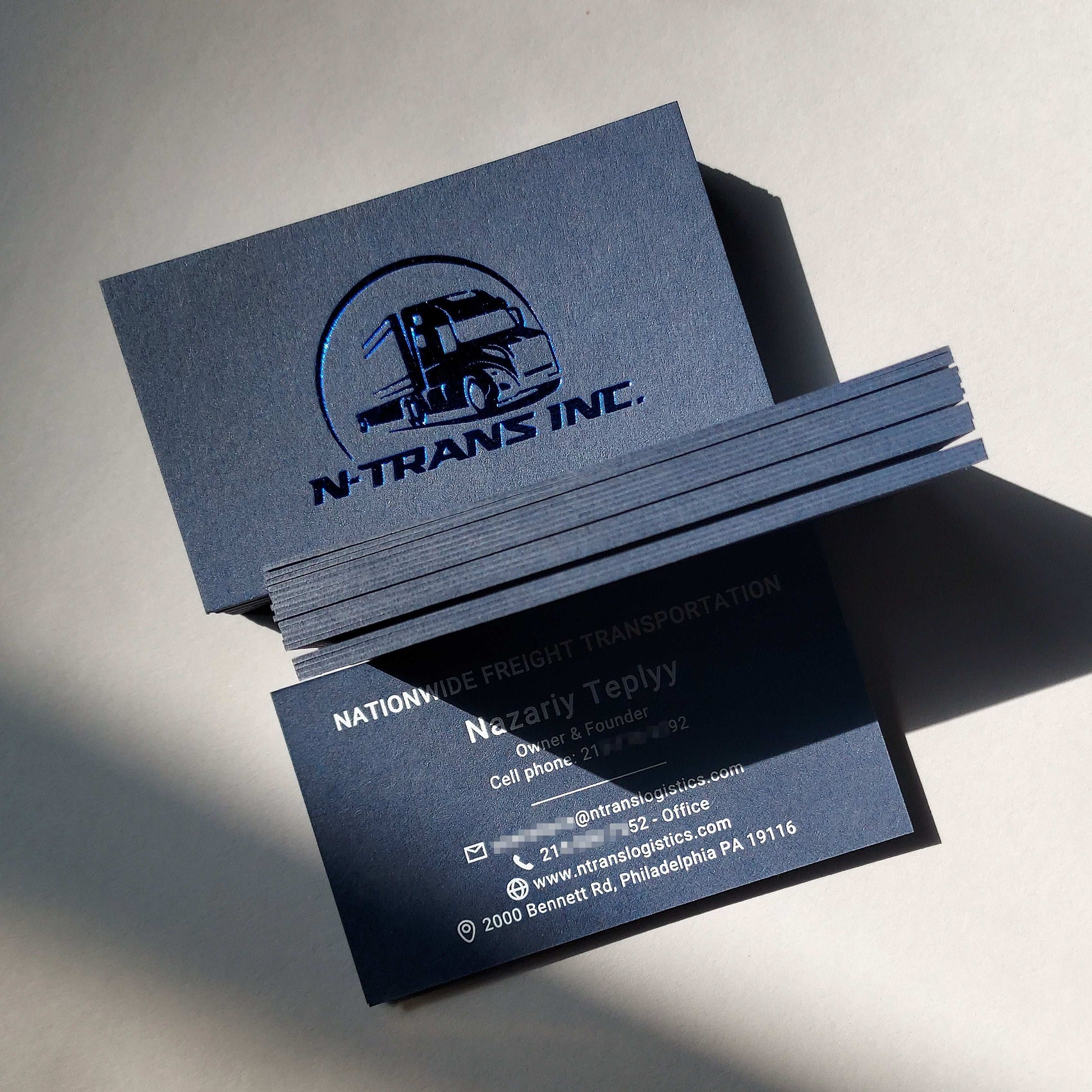 Handcrafted thick blue business card featuring letterpress and blind emboss for small business owners