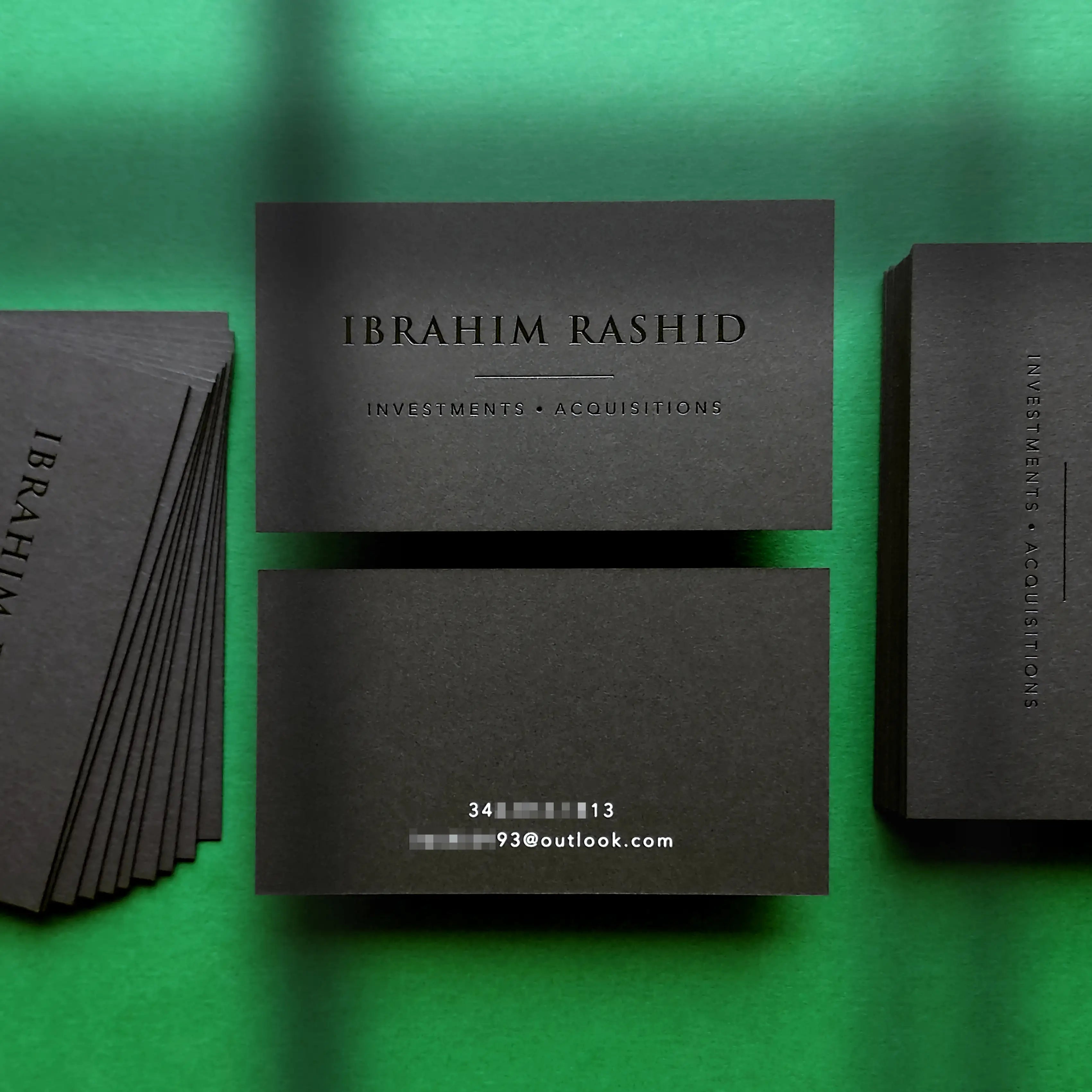 Custom black business cards 38pt 700gsm featuring glossy black foil and crisp white foil made by OddPlanPrint.