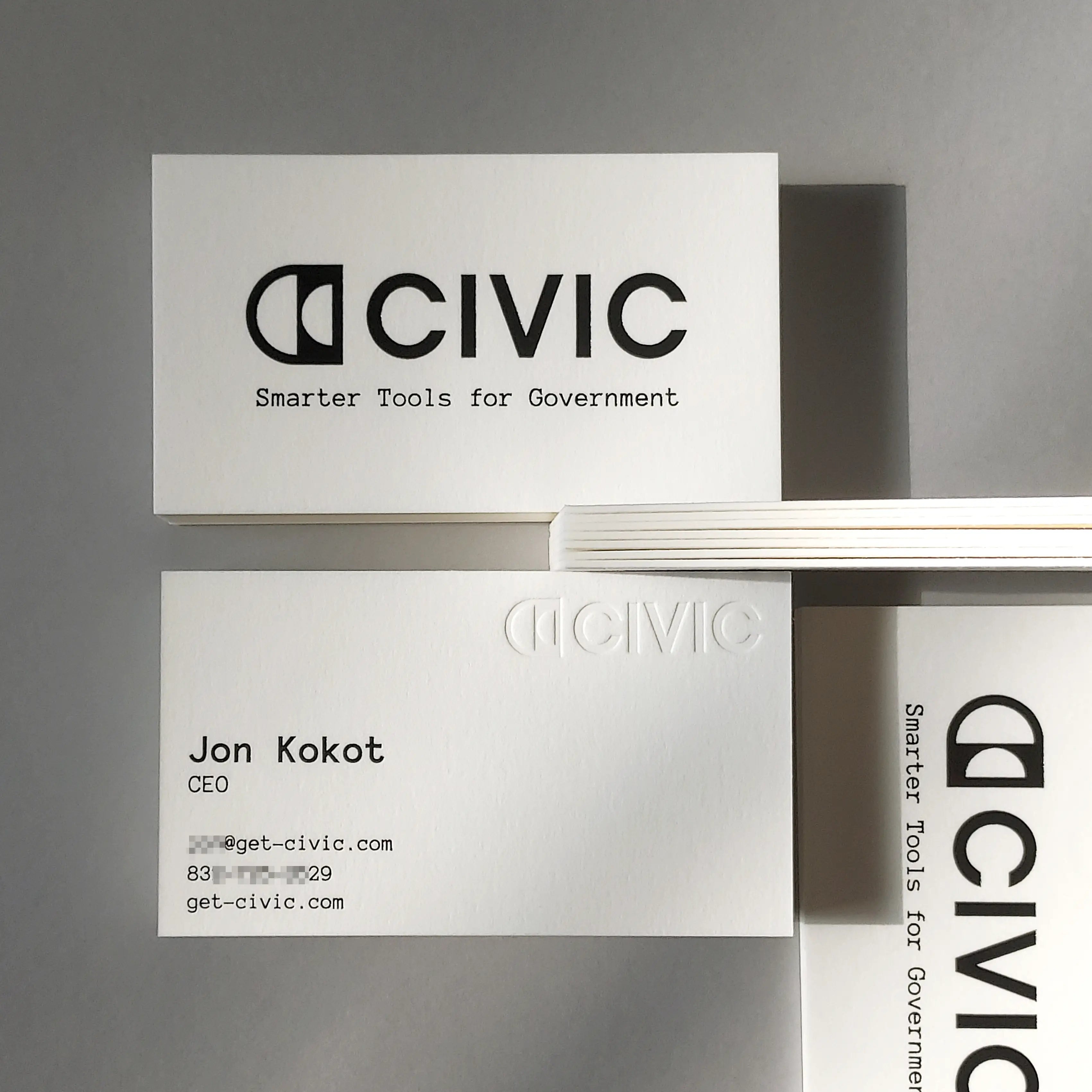 Luxury custom cotton business cards, 45pt thickness, featuring elegant black foil stamping and deep debossing from OddPlanPrint