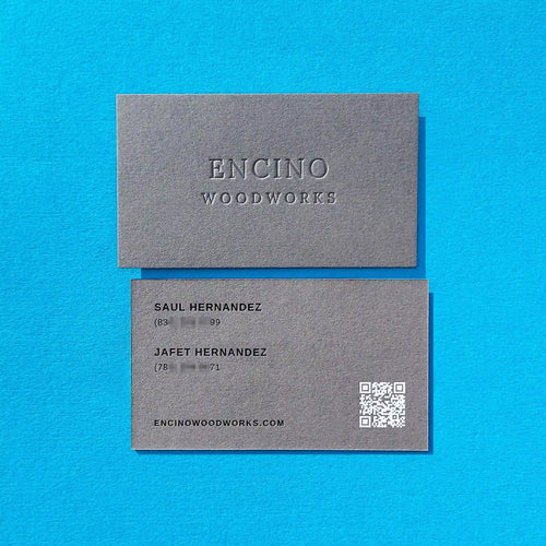 Dark grey business cards 30pt 540gsm with deboss, black foil and white foil produced by OddPlanPrint.