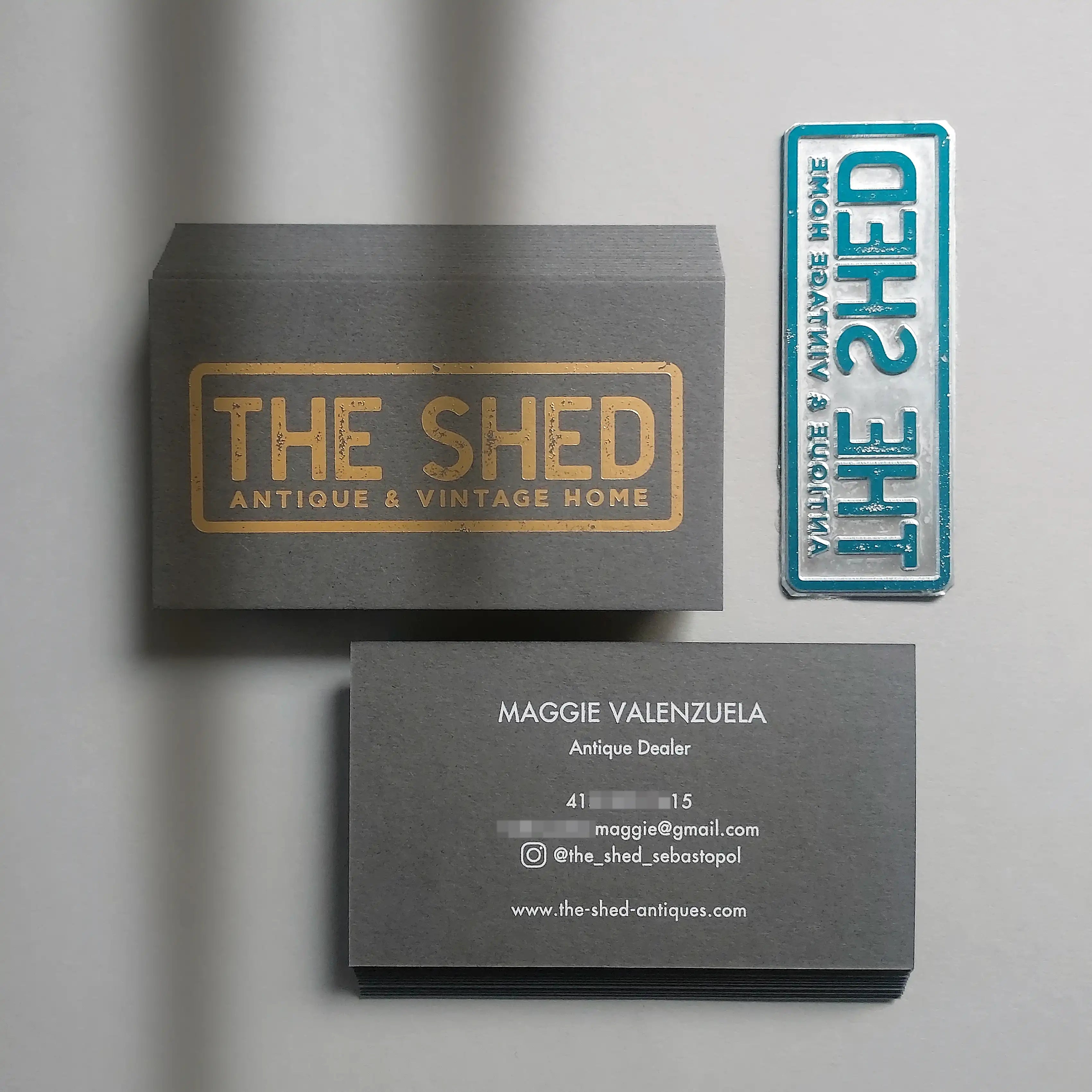 Elegant dark grey business cards featuring gold foil logo and white foil name details - OddPlanPrint