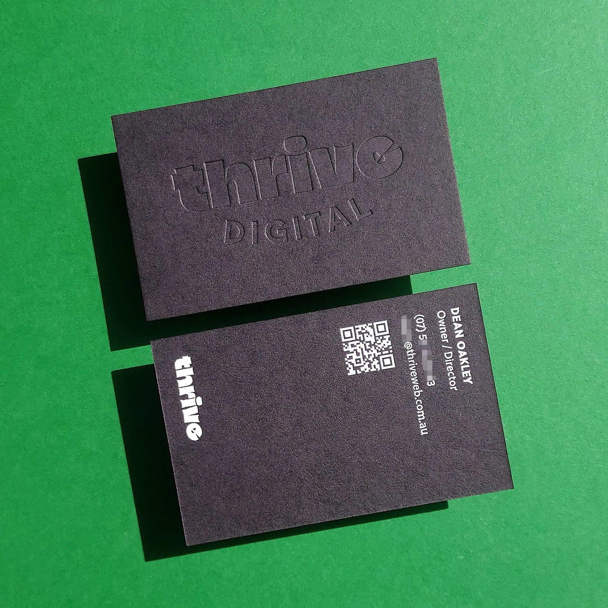 Premium thick black card with subtle blind deboss design