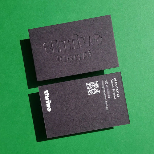 Premium thick black card with subtle blind deboss design