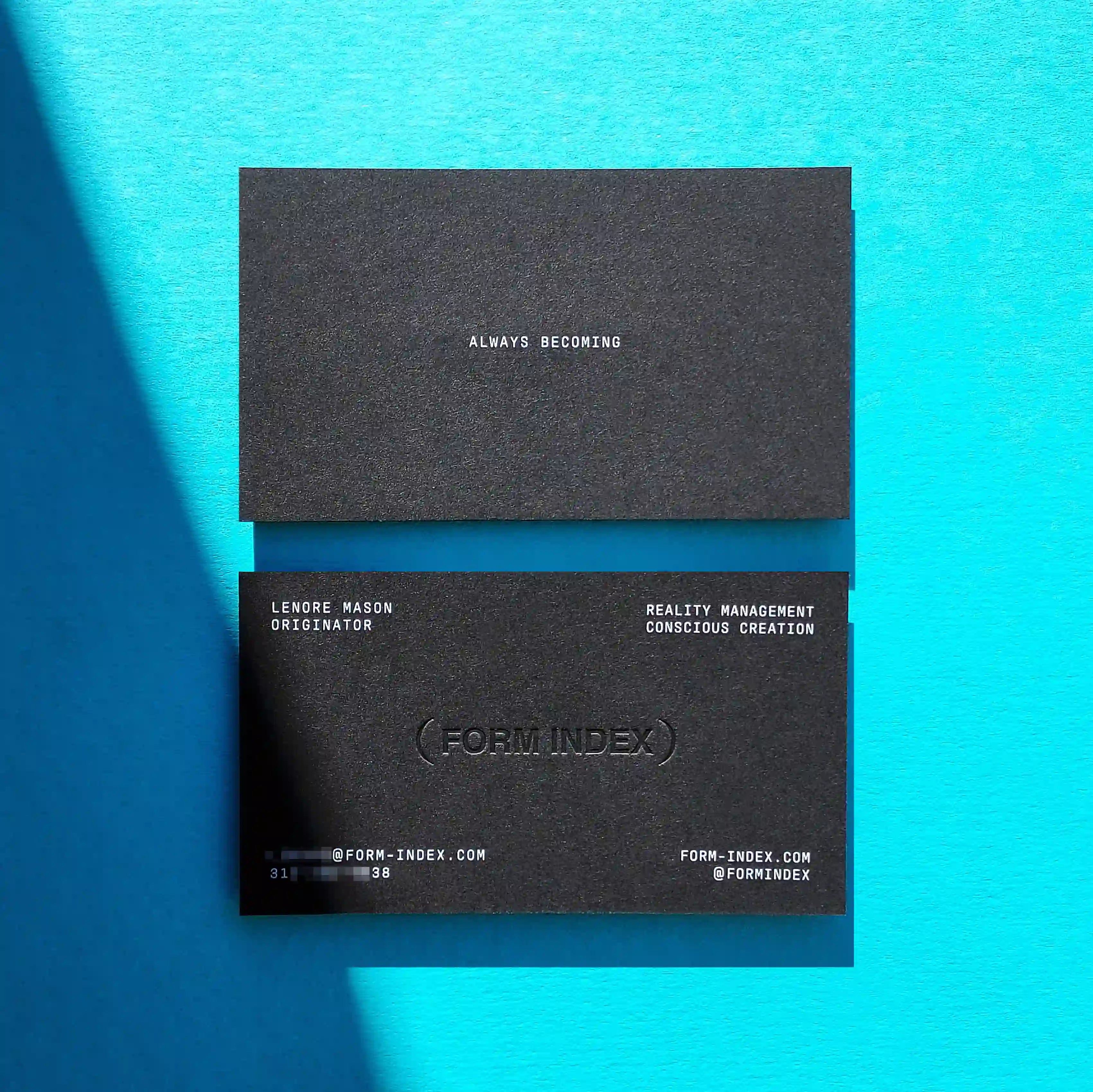 Modern black debossed business cards 38pt thick with deboss and white printing produced by OddPlanPrint.