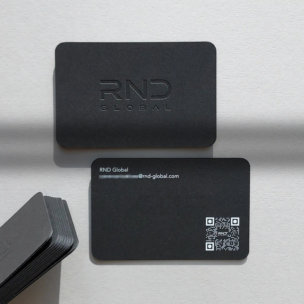 Debossed black business cards 38pt with white printing and rounded corners by OddPlanPrint.