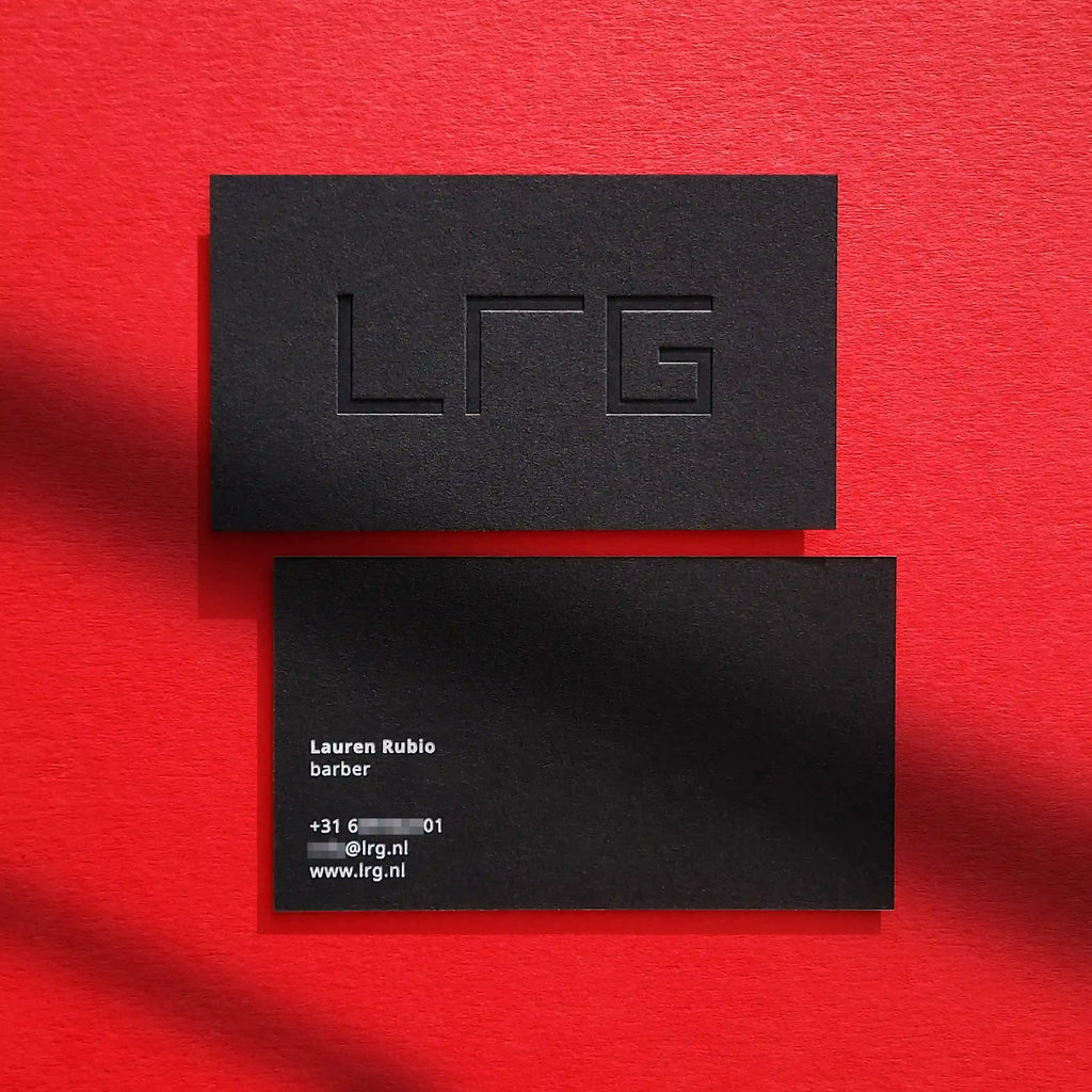 Thick 38pt debossed black business cards featuring white foil accents from OddPlanPrint.