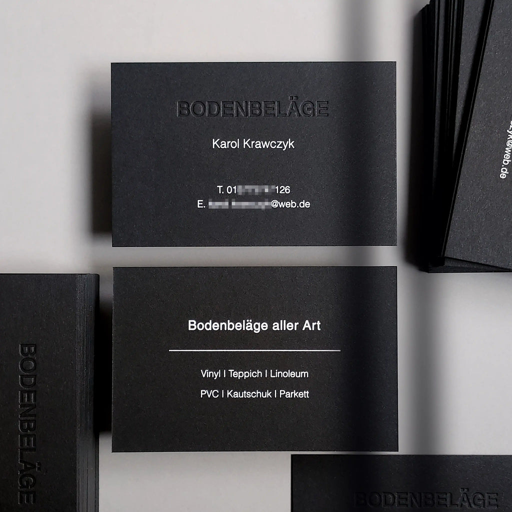 Black business cards with blind deboss and white foil on 38pt thick stock by OddPlanPrint