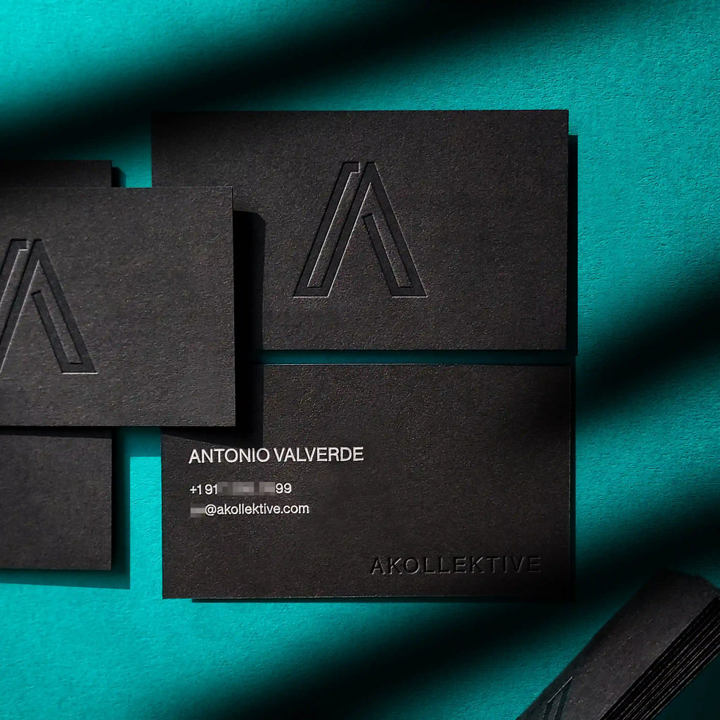 Premium black 38pt debossed business cards with silver matte foil produced by OddPlanPrint.