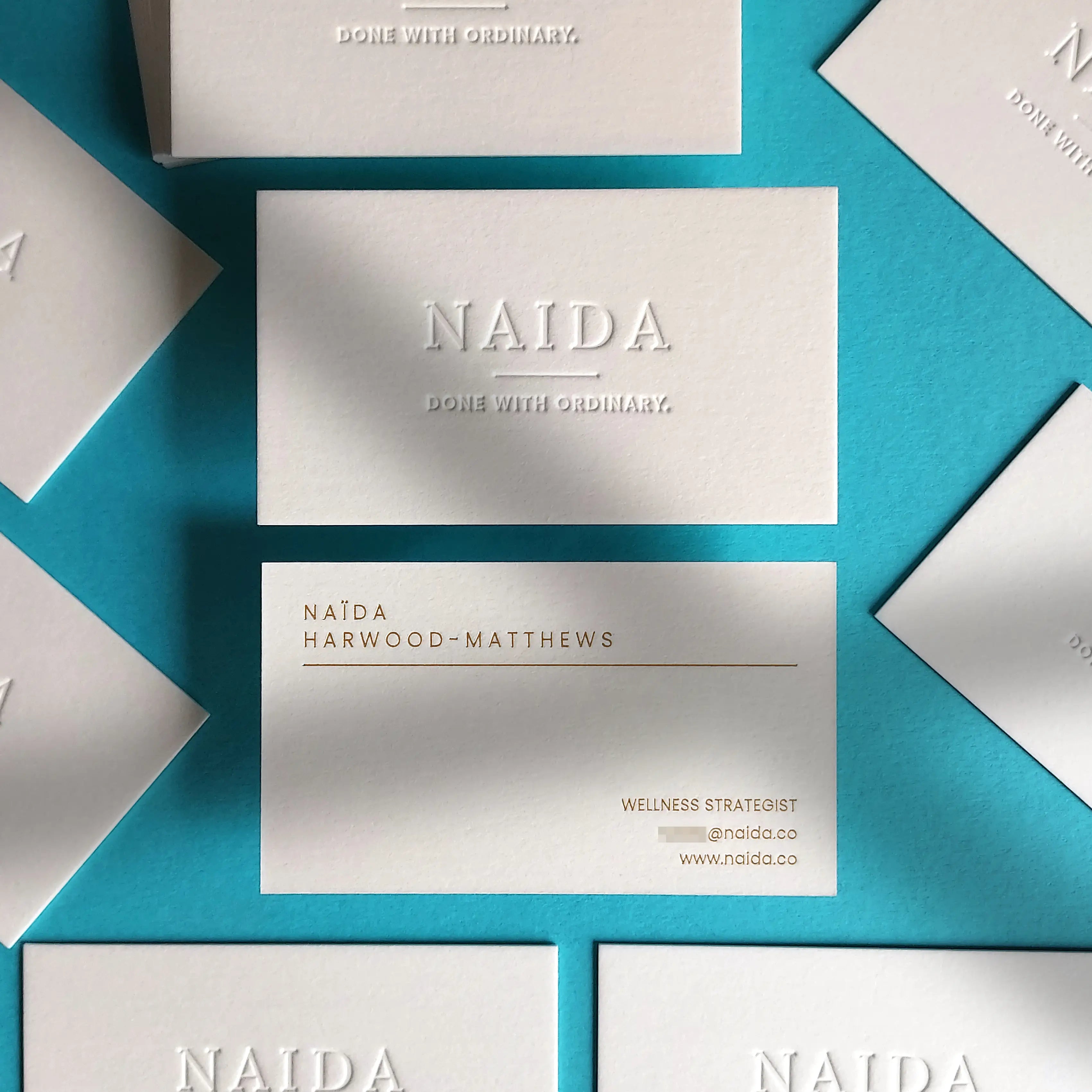 Heavyweight 45pt debossed stationery and matte gold foil business cards designed and manufactured by OddPlanPrint.