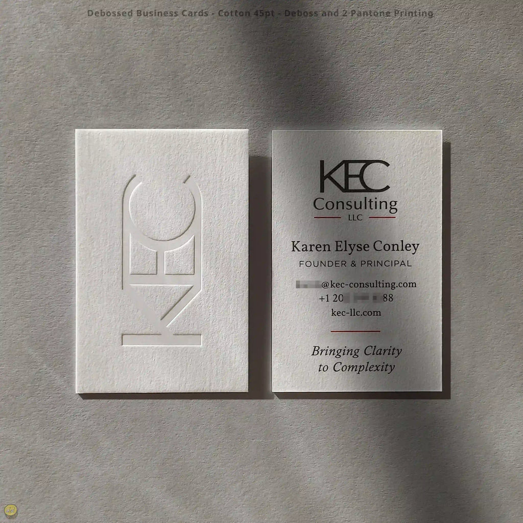 Debossed business cards combine soft 45pt cotton with two Pantone colors, crafted by OddPlanPrint.