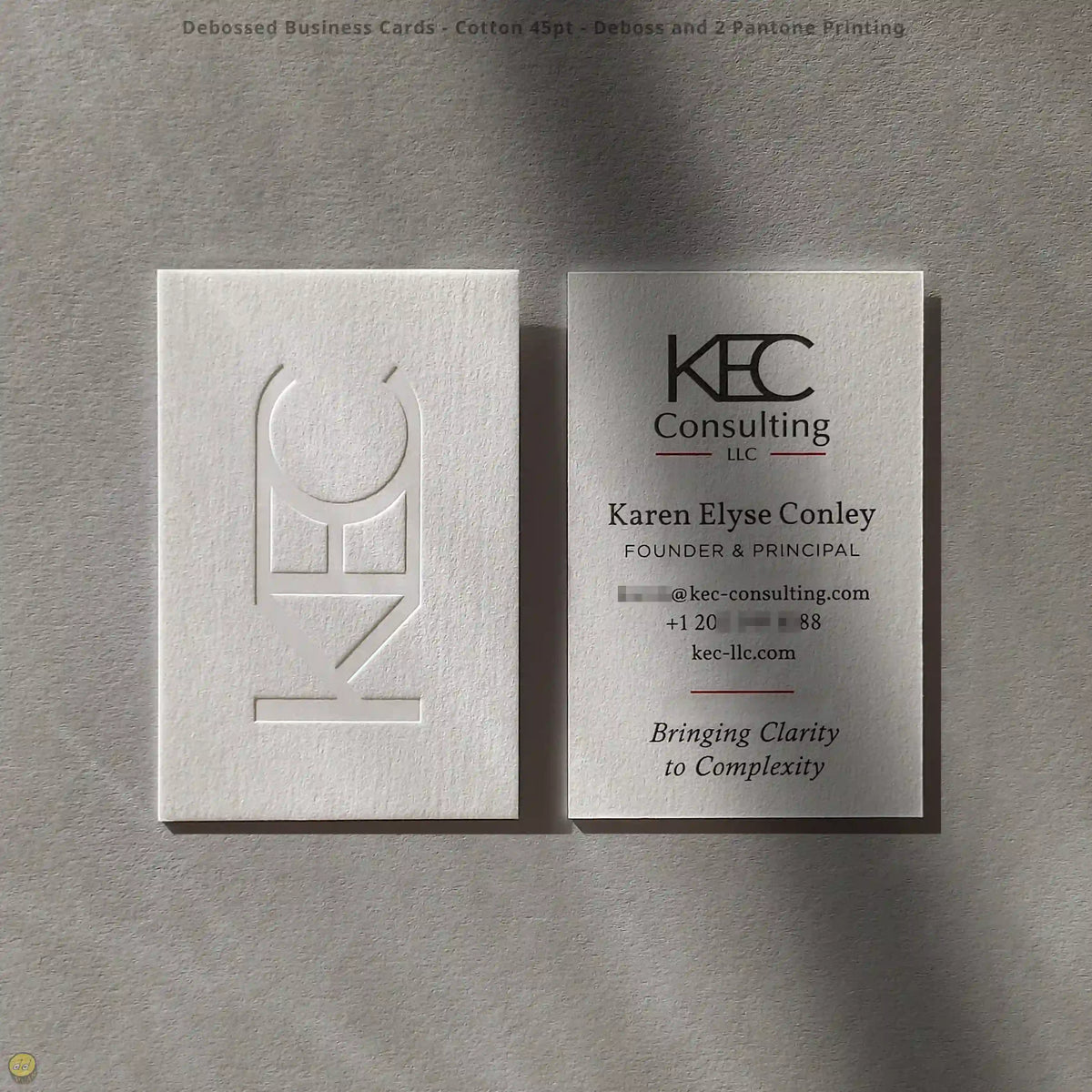 Debossed business cards combine soft 45pt cotton with two Pantone colors, crafted by OddPlanPrint.