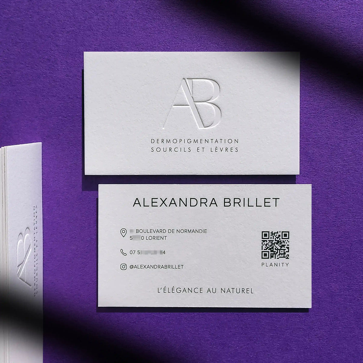Deep debossed logo on thick 45pt cotton paper business cards printed with black ink by OddPlanPrint.