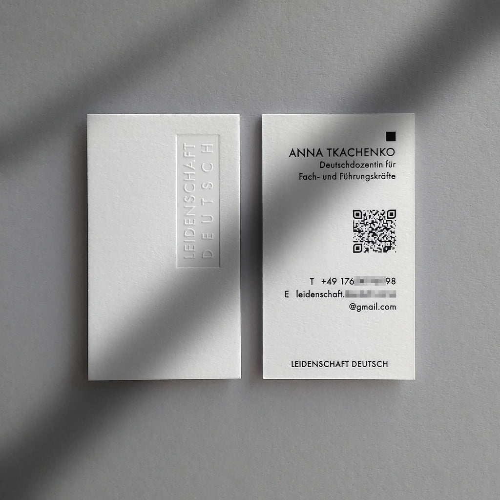 Heavy 45pt cotton debossed business cards with blind deboss and glossy black foil made by OddPlanPrint.