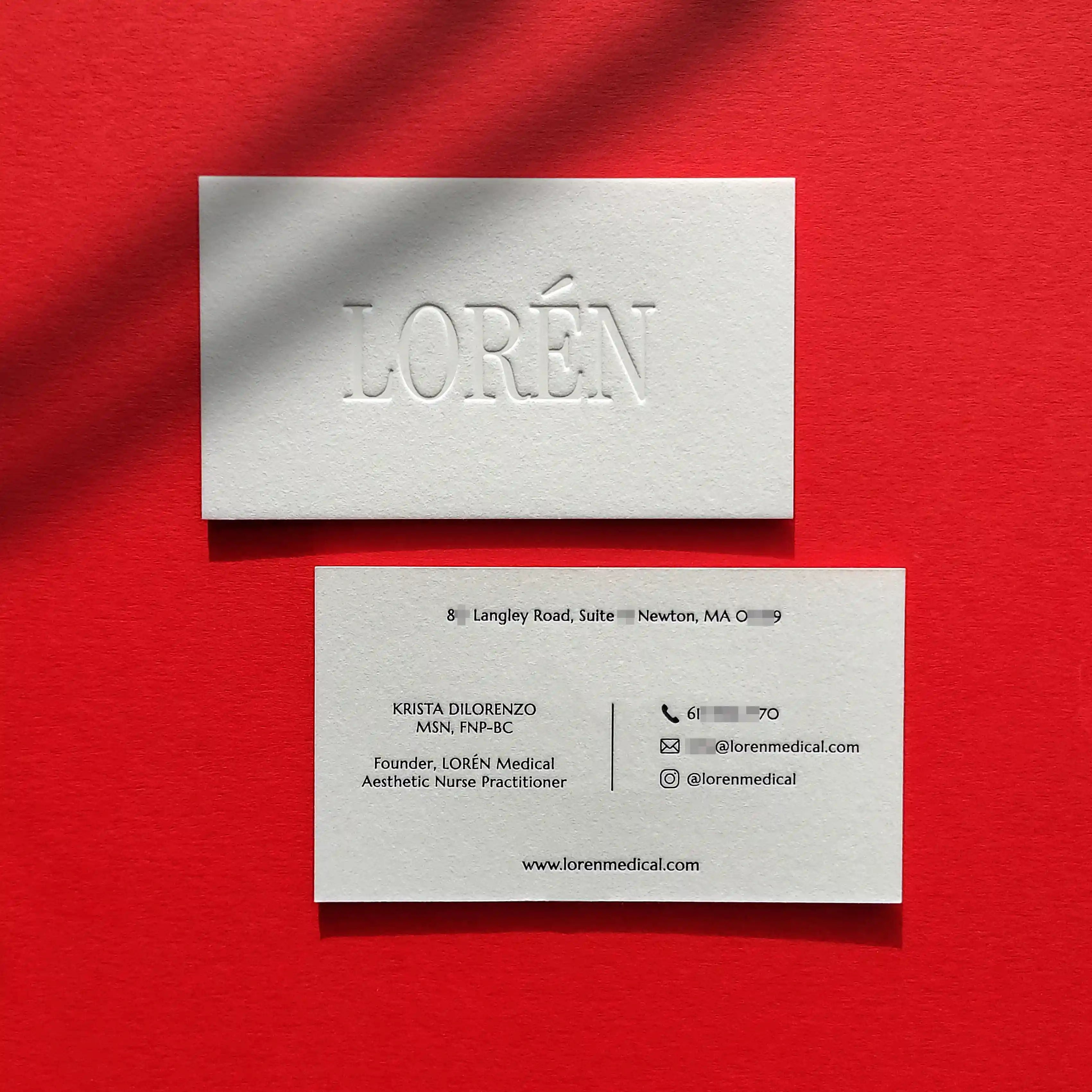 Luxury debossed cotton business cards featuring black glossy foil stamping from OddPlanPrint.