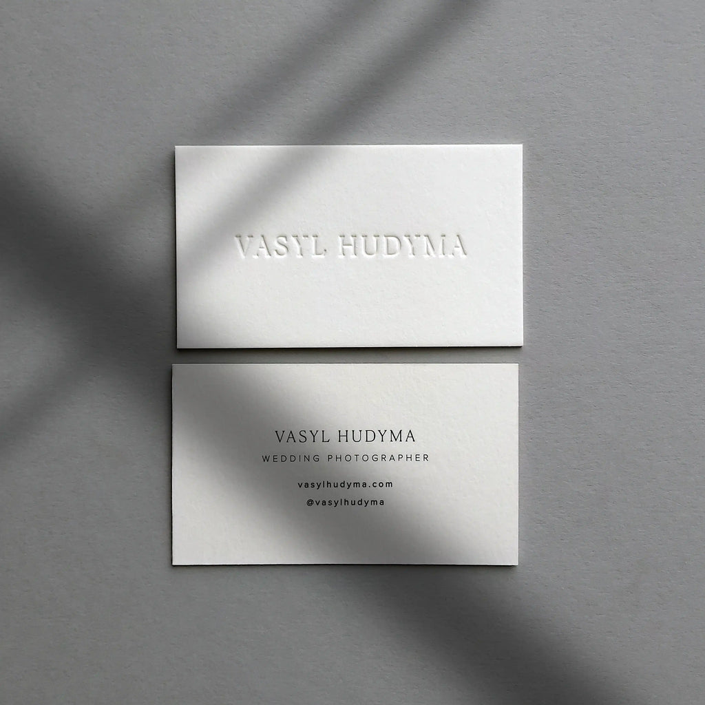 Thick debossed 45pt cotton business cards featuring black printing details made by OddPlanPrint.