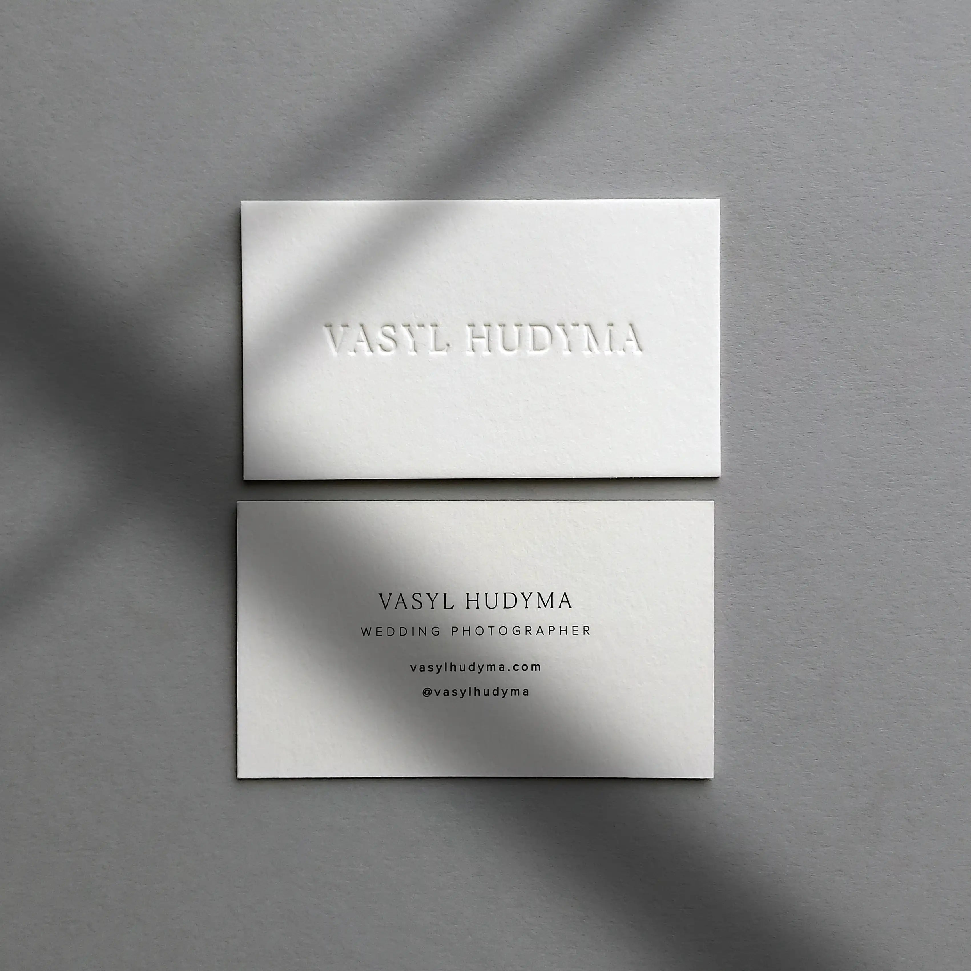 Thick debossed 45pt cotton business cards featuring black printing details made by OddPlanPrint.