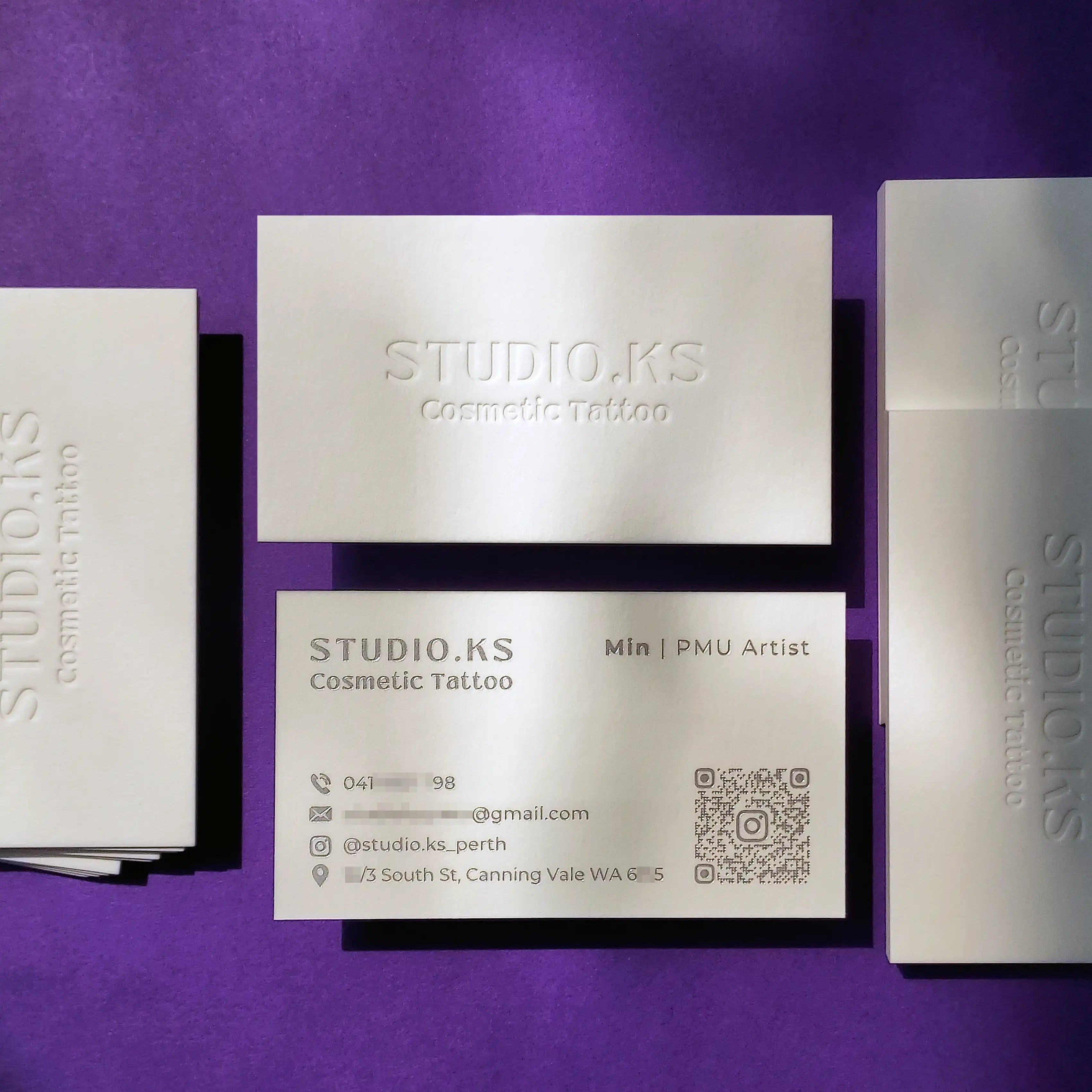 Premium debossed cotton business cards 45pt with deep blind deboss and silver foil made by OddPlanPrint.