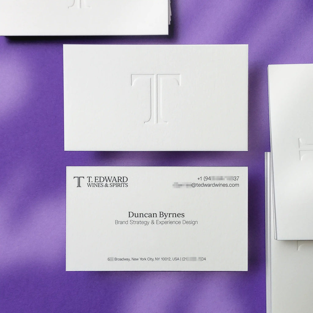 Debossed logo pressed deep into natural cotton card stock - black ink on the reverse side, 45pt thickness visible at the edge. Printed by OddPlanPrint.