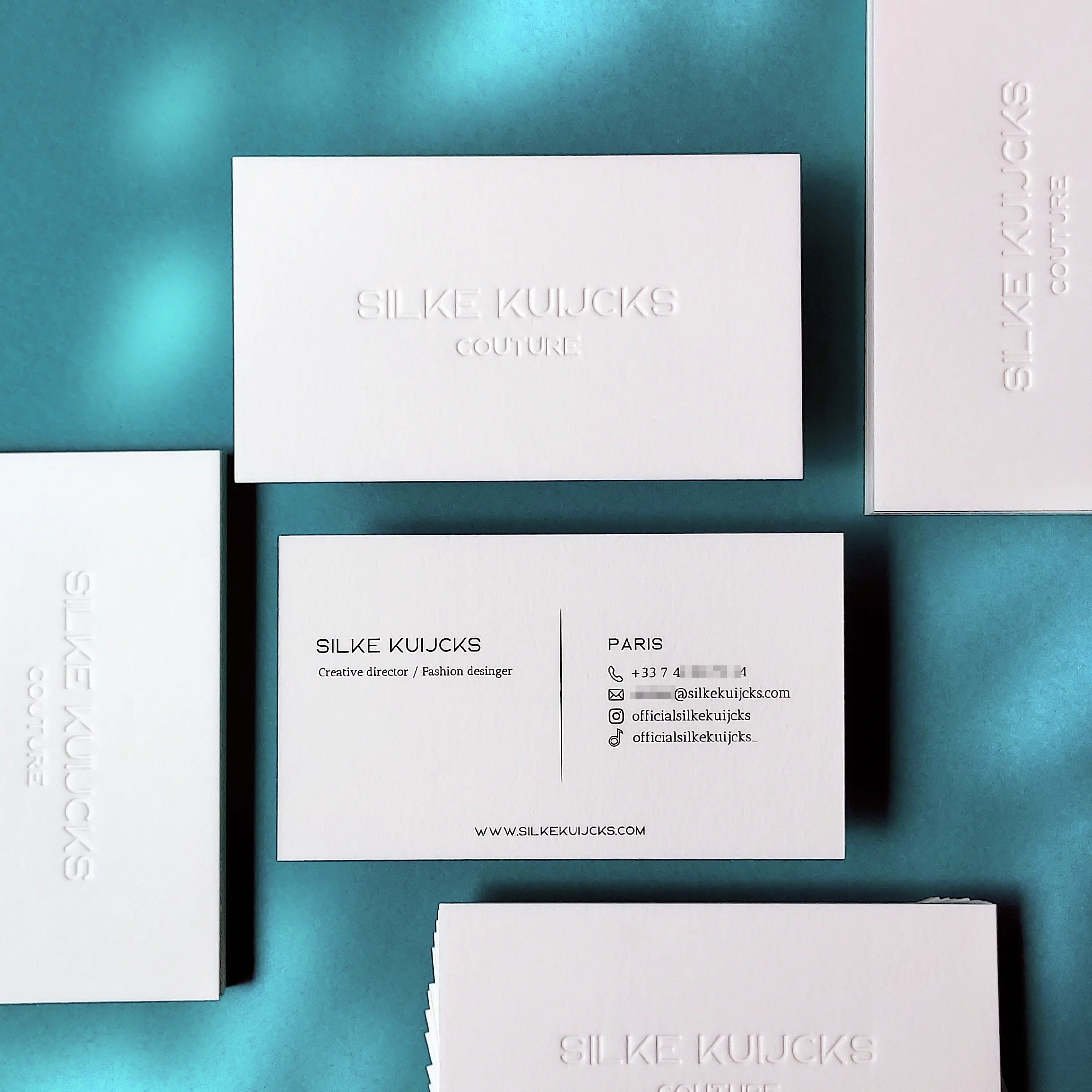 Debossed cotton business cards 45pt black printing OddPlanPrint - premium blind deboss finish on 750gsm natural cotton stock. Best luxury custom business cards with tactile print finish.