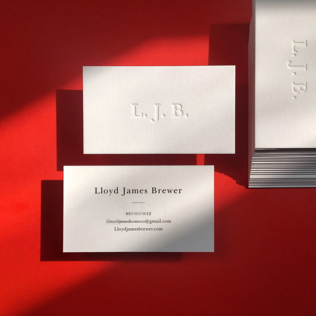 Luxury 45pt cotton debossed business cards featuring blind deboss and charcoal printing by OddPlanPrint.