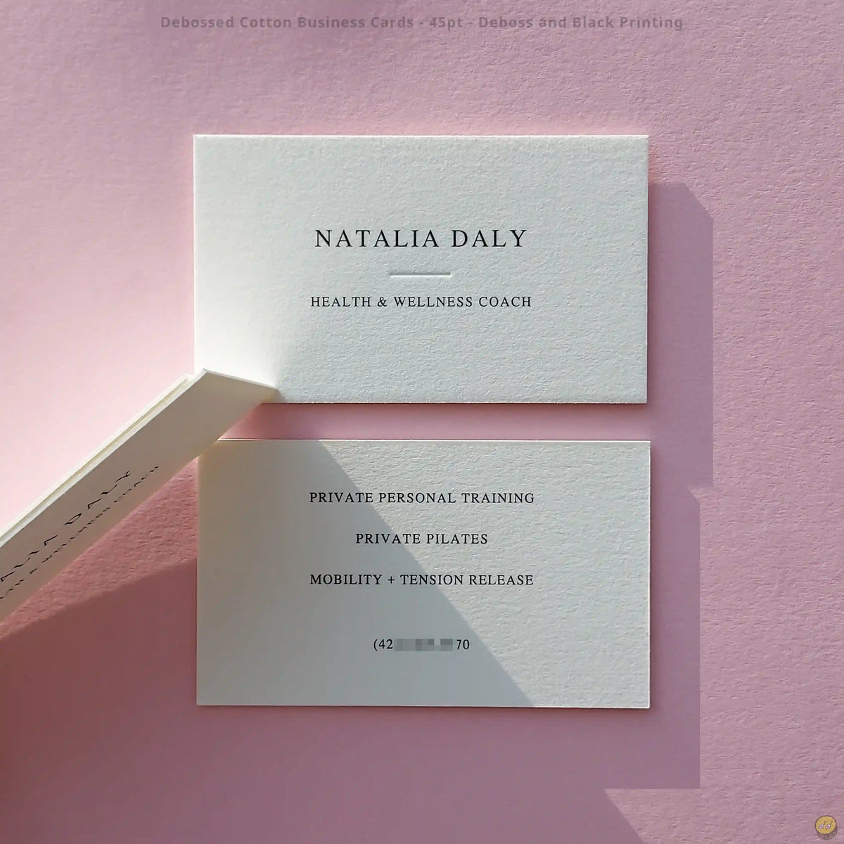 Debossed cotton business cards create logo depth with black printing by OddPlanPrint on 45pt stock.