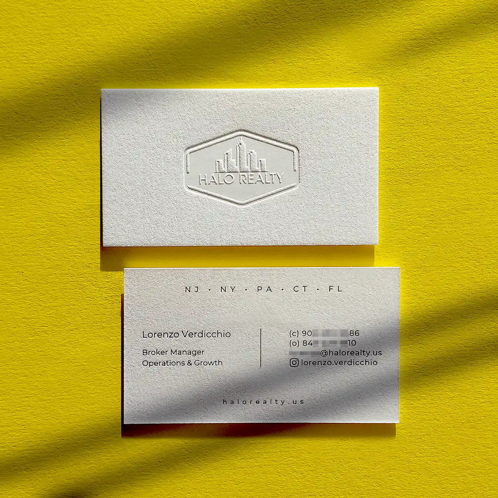 Thick 45pt cotton debossed business cards with deep blind deboss and glossy black foil created by OddPlanPrint.