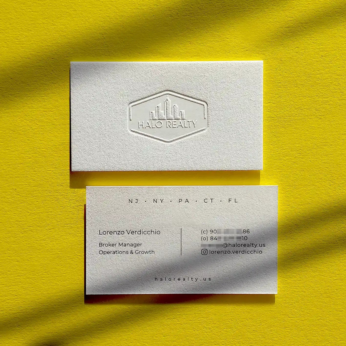 Thick 45pt cotton debossed business cards with deep blind deboss and glossy black foil created by OddPlanPrint.