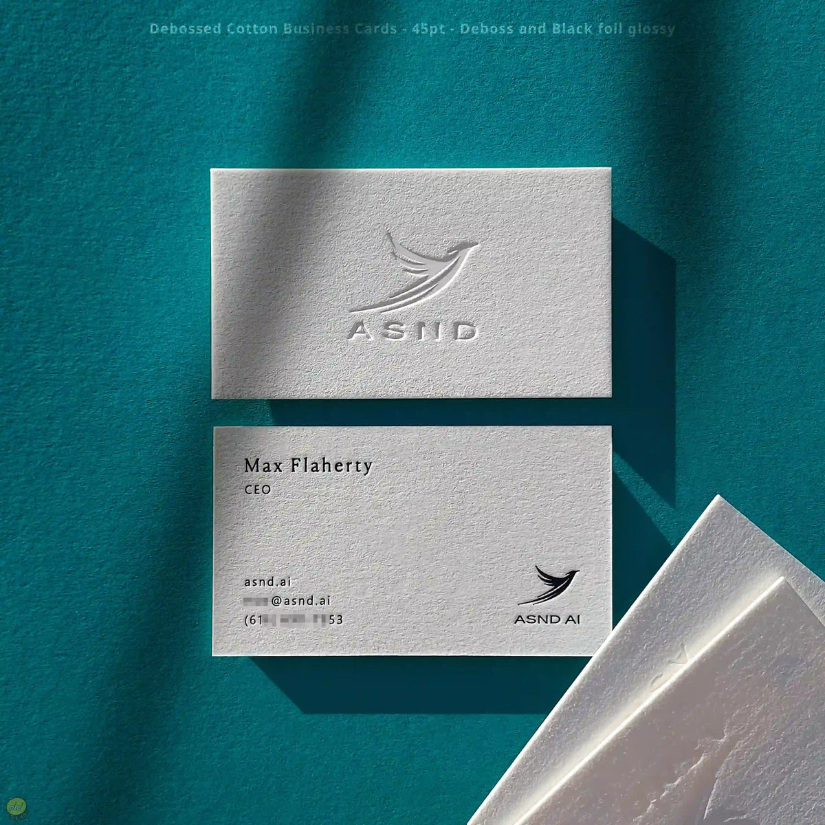 Cotton business cards pair deep debossing with glossy black foil by OddPlanPrint on 45pt stock.