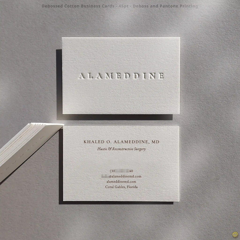 Thick cotton business cards finished with blind deboss and brown Pantone by OddPlanPrint.