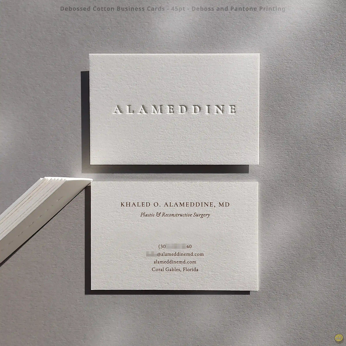 Thick cotton business cards finished with blind deboss and brown Pantone by OddPlanPrint.