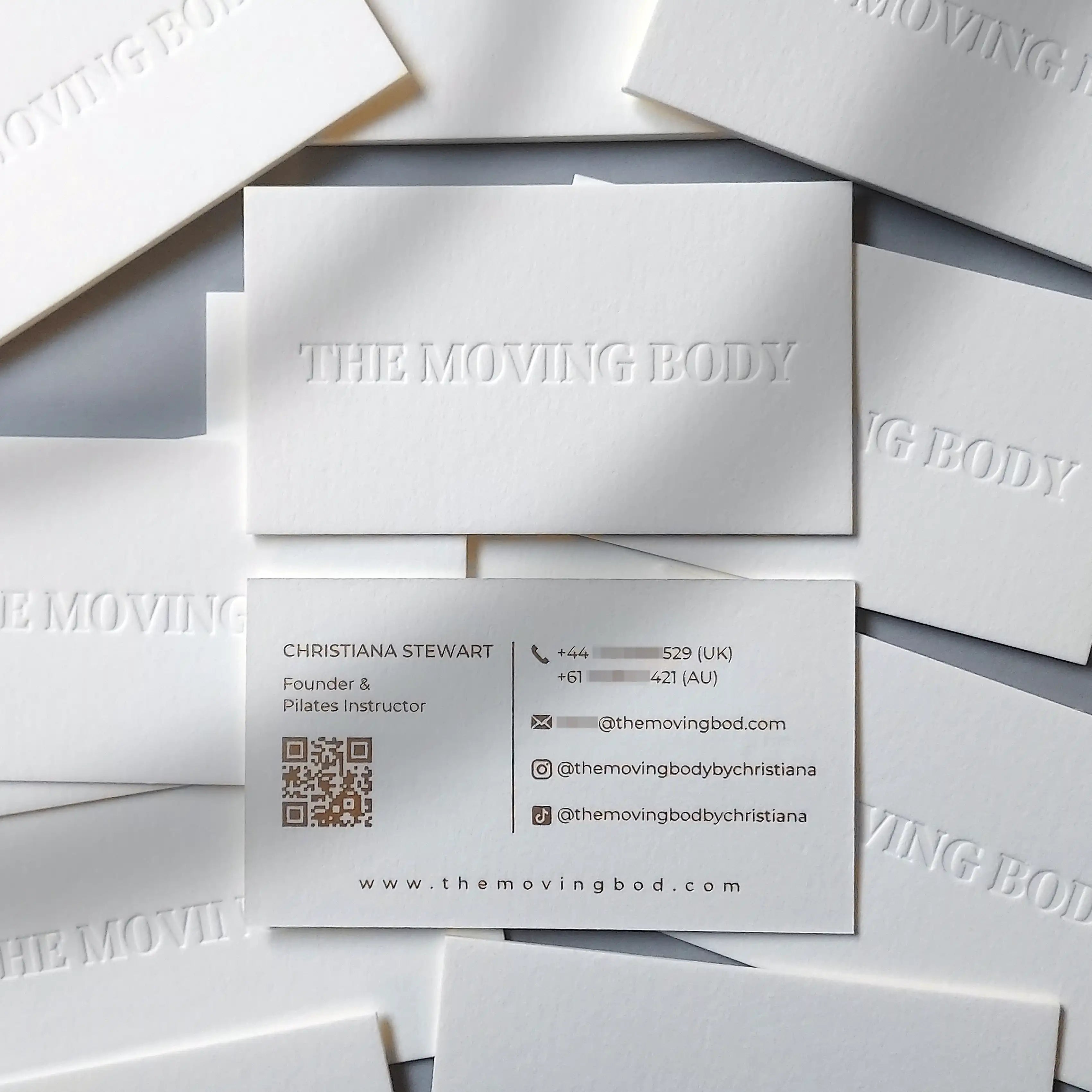 Premium business card with blind deboss detail and matte gold foil text on thick 45pt cotton stock.