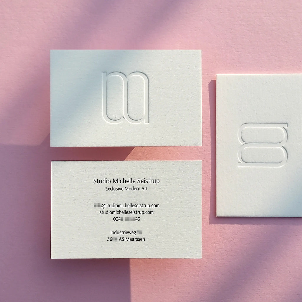 Debossed business cards 45pt with blind deboss and glossy black foil made by OddPlanPrint.