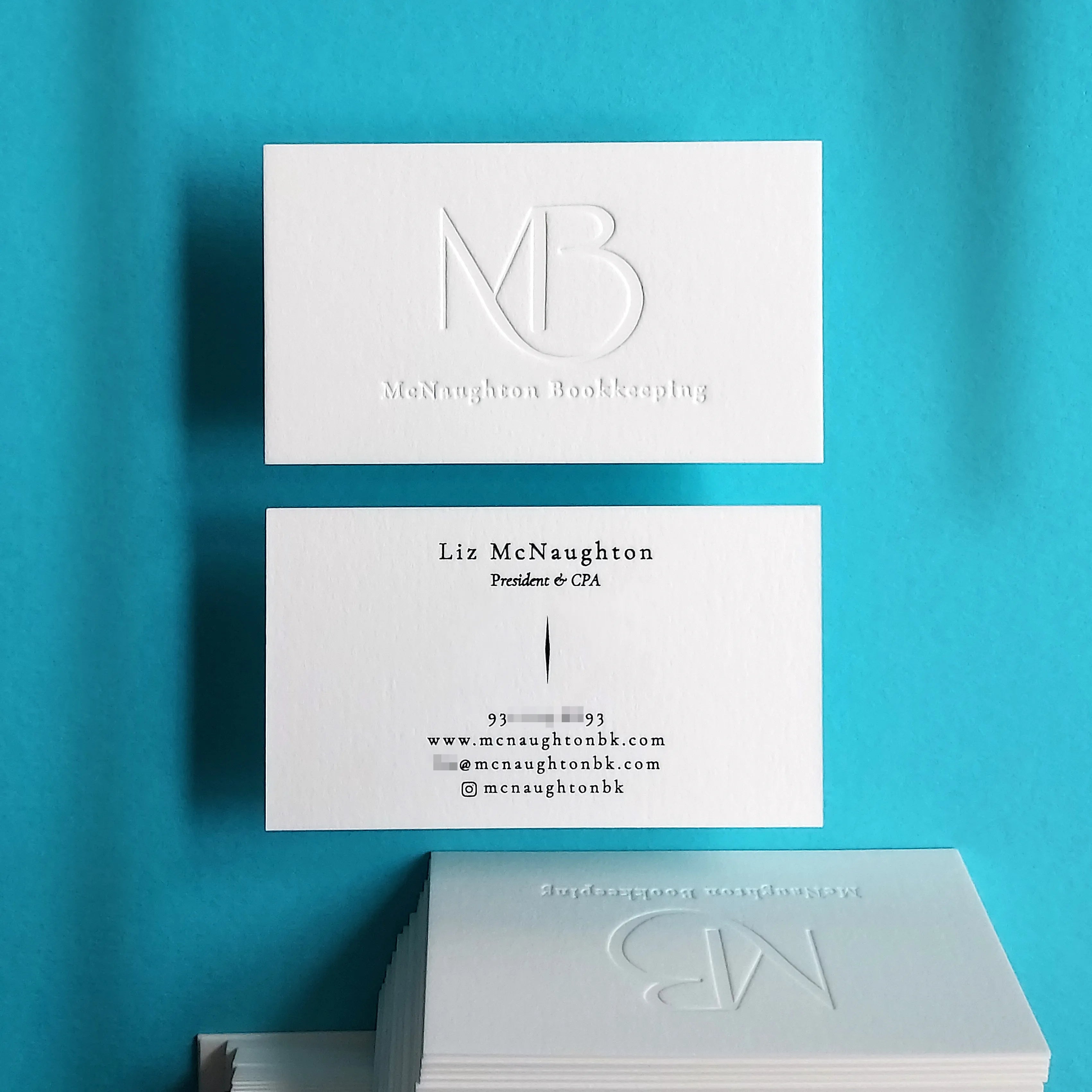 Debossed business cards by OddPlanPrint, with Cotton 45pt, glossy black foil.