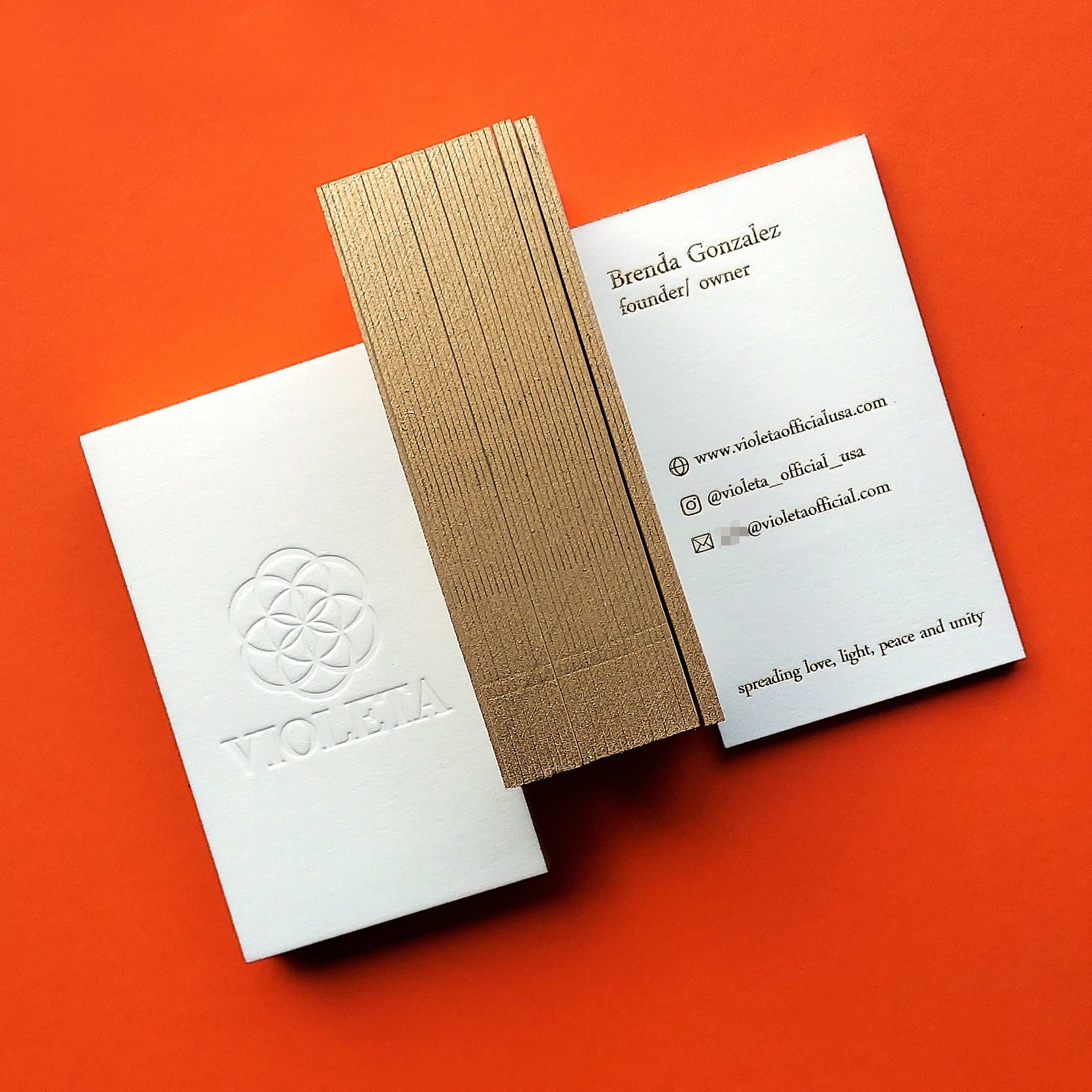 Cotton business card with gold sides, foil and deboss.