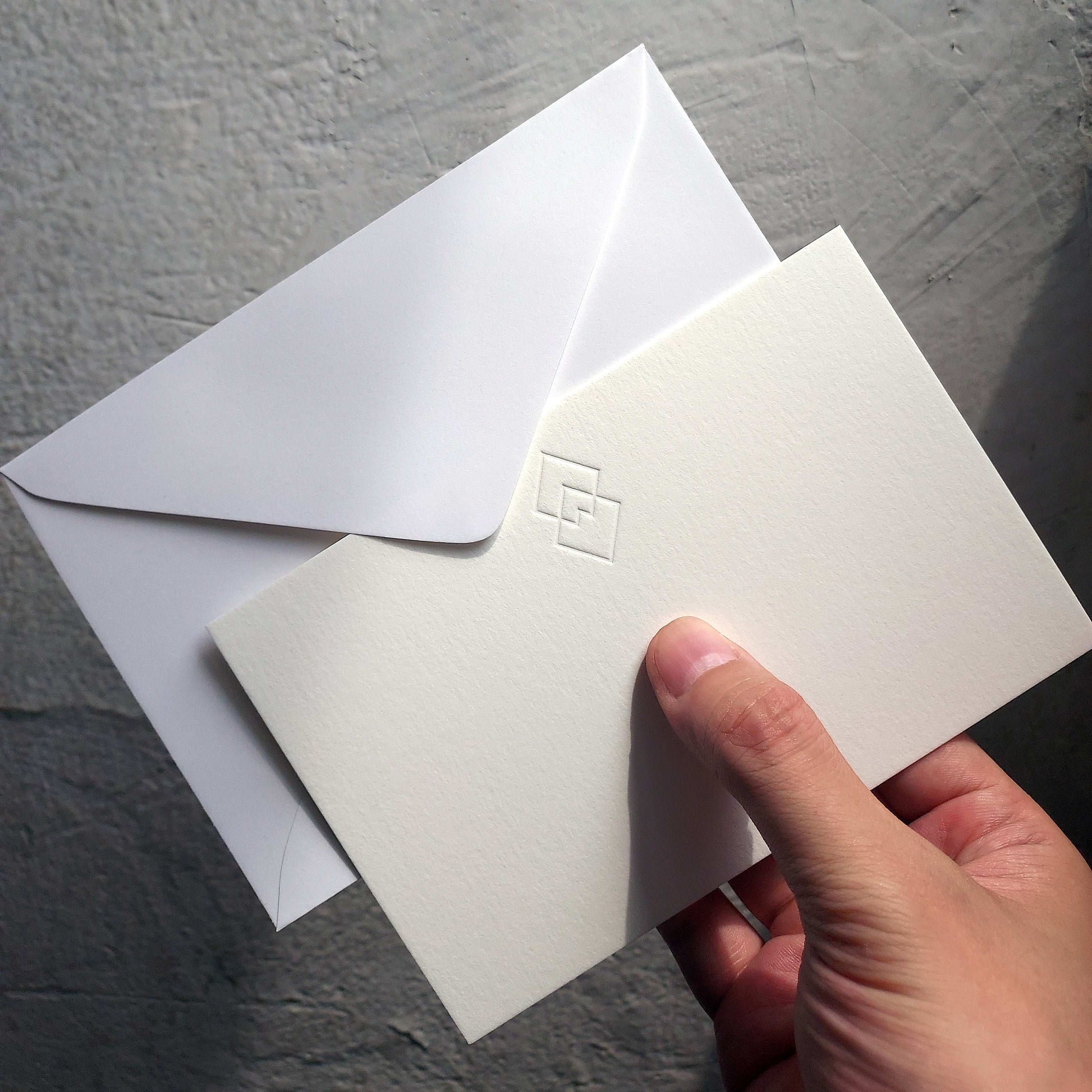 Cotton postcard with debossed logo and luxe matching envelope
