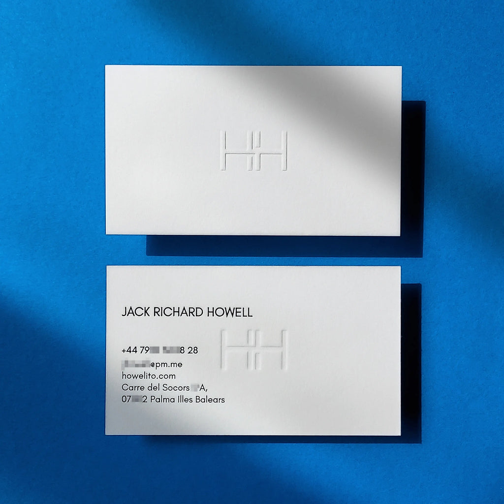 Embossed business cards on 45pt 750gsm cotton with raised emboss and glossy black foil made by OddPlanPrint.
