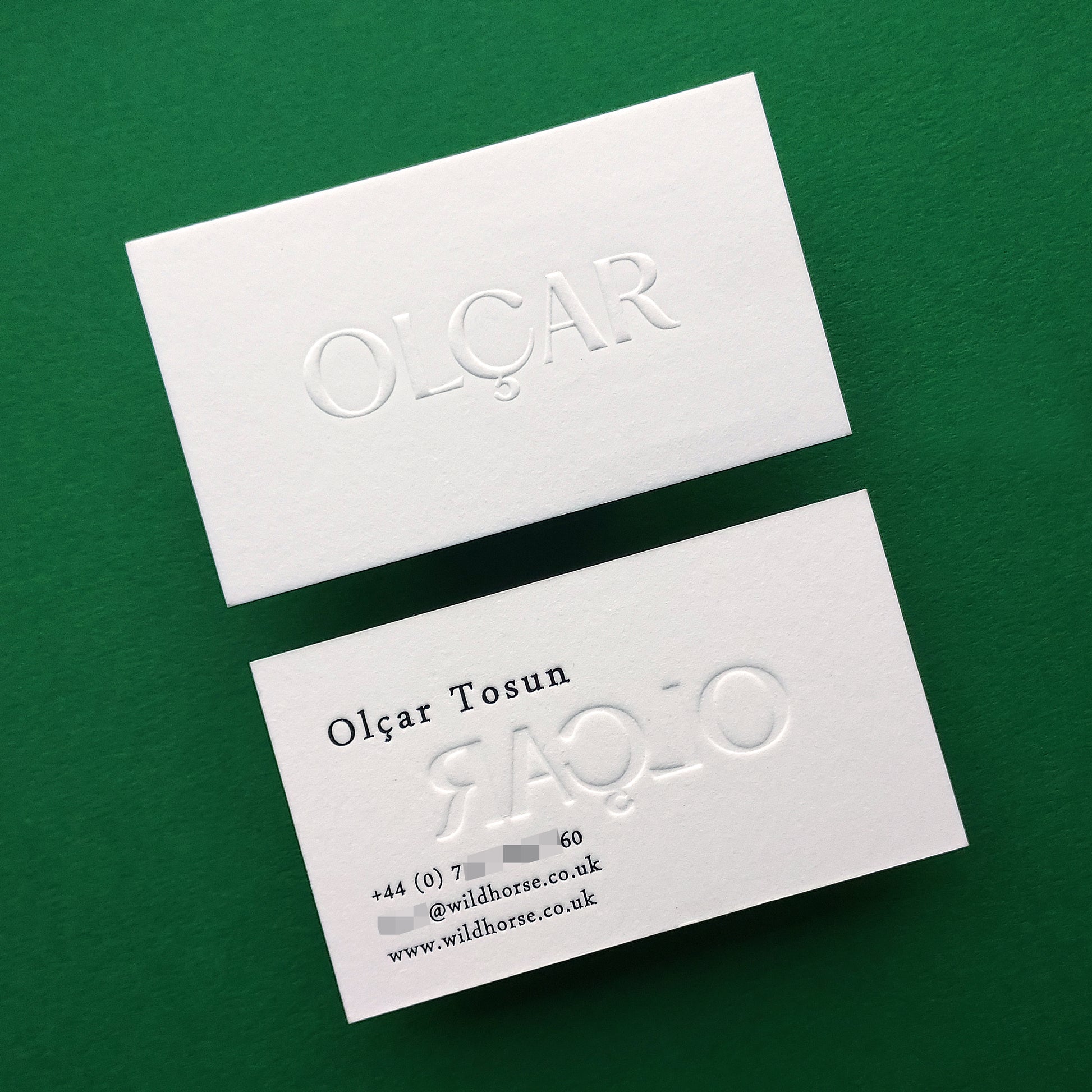 Embossed business card with black foil