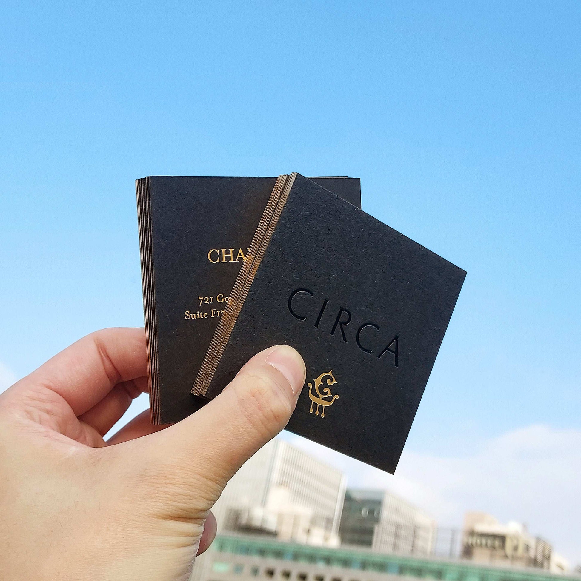 Thick black card featuring custom gold-painted edge and luxurious texture.