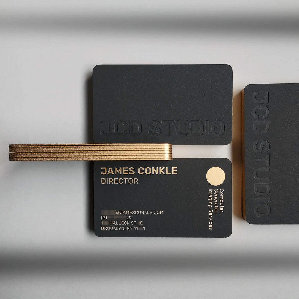 Close view of 38pt black card with metallic gold painted edge, debossed logo, and rounded corners | OddPlanPrint